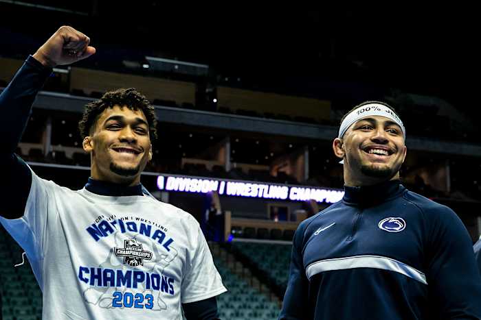 Penn State wrestlers Carter Starocci, left, and Aaron Brooks celebrate winning individual and team titles at the NCAA Wrestling Championships.